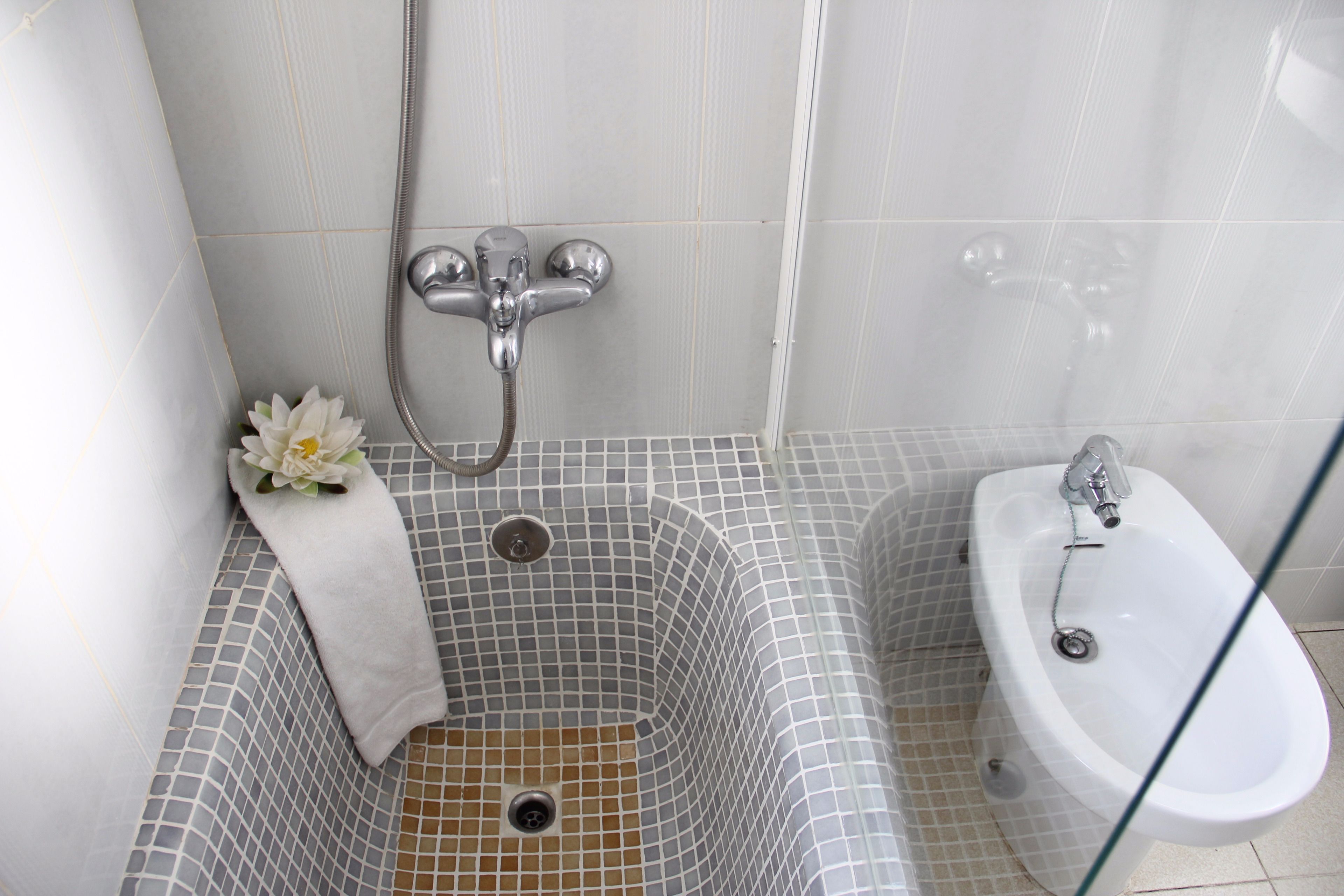 A bathroom with a bathtub, a shower, and a sink.