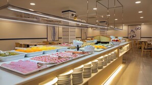 A buffet with various food items and stacked plates. - Medplaya Bali (Benalmádena)