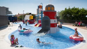 A water park with a central water slide, inflatable rings, and a pool area. - Medplaya Bali (Benalmádena)