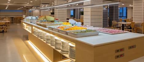 A buffet area with various food options, a seating area with tables and chairs, and a modern interior design.