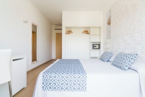 Une chambre à coucher avec un lit, une armoire et un miroir.