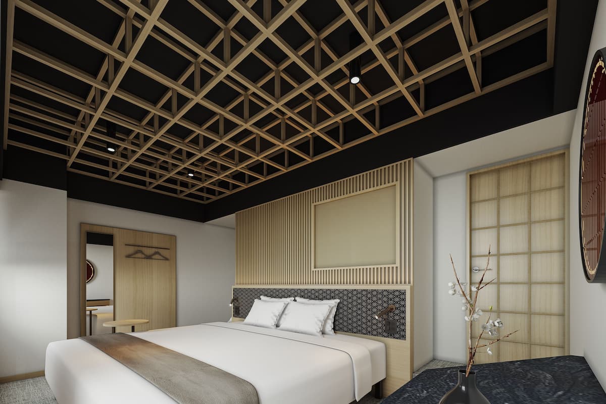 A modern bedroom with a large bed, a bedside table, a vase with branches, and a wooden ceiling design.