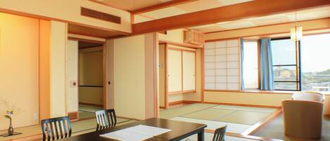 A traditional Japanese-style room with tatami flooring, a low table, and shoji screens.