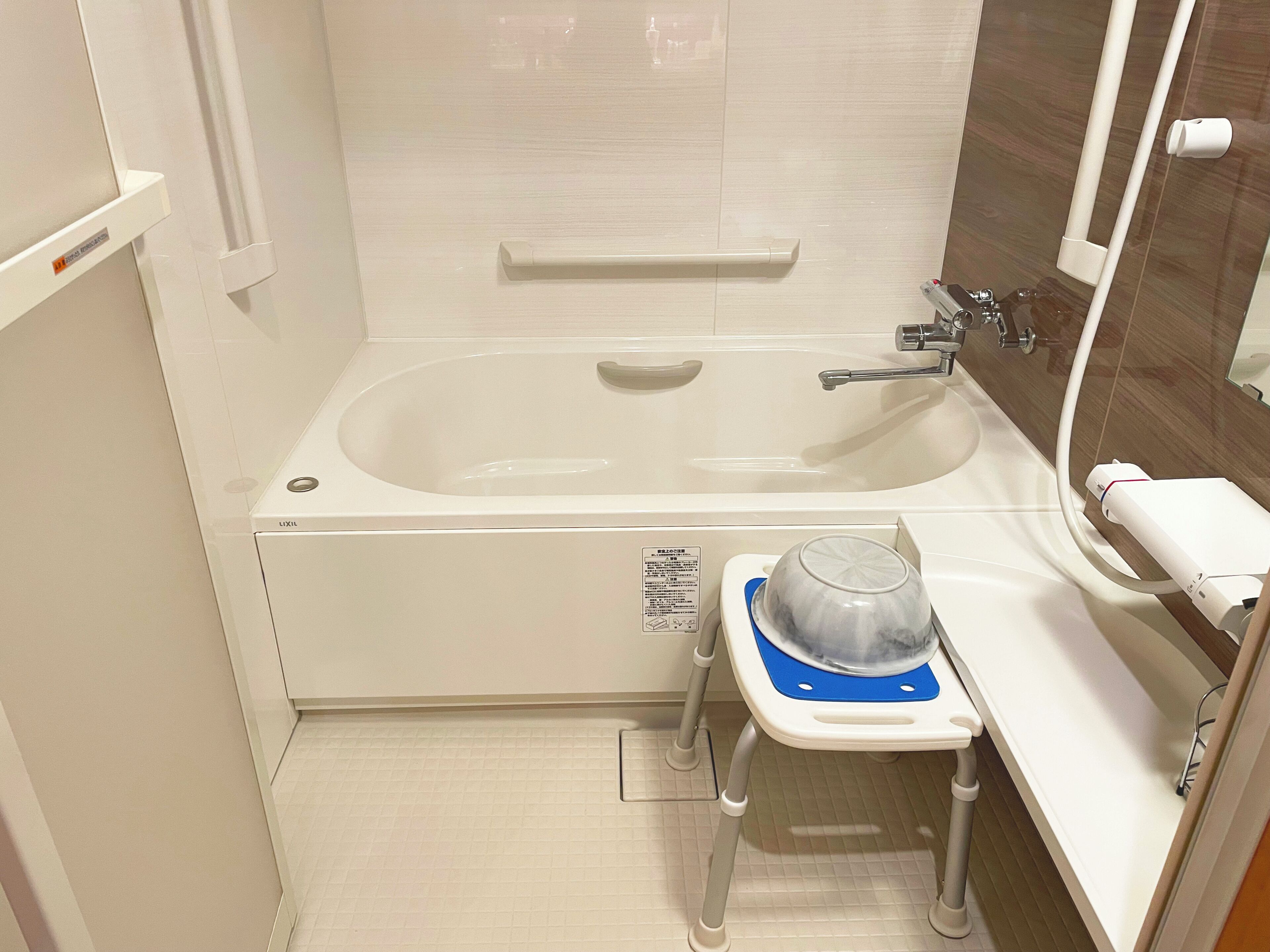 A bathroom with a bathtub, a toilet, a sink, and a mirror.