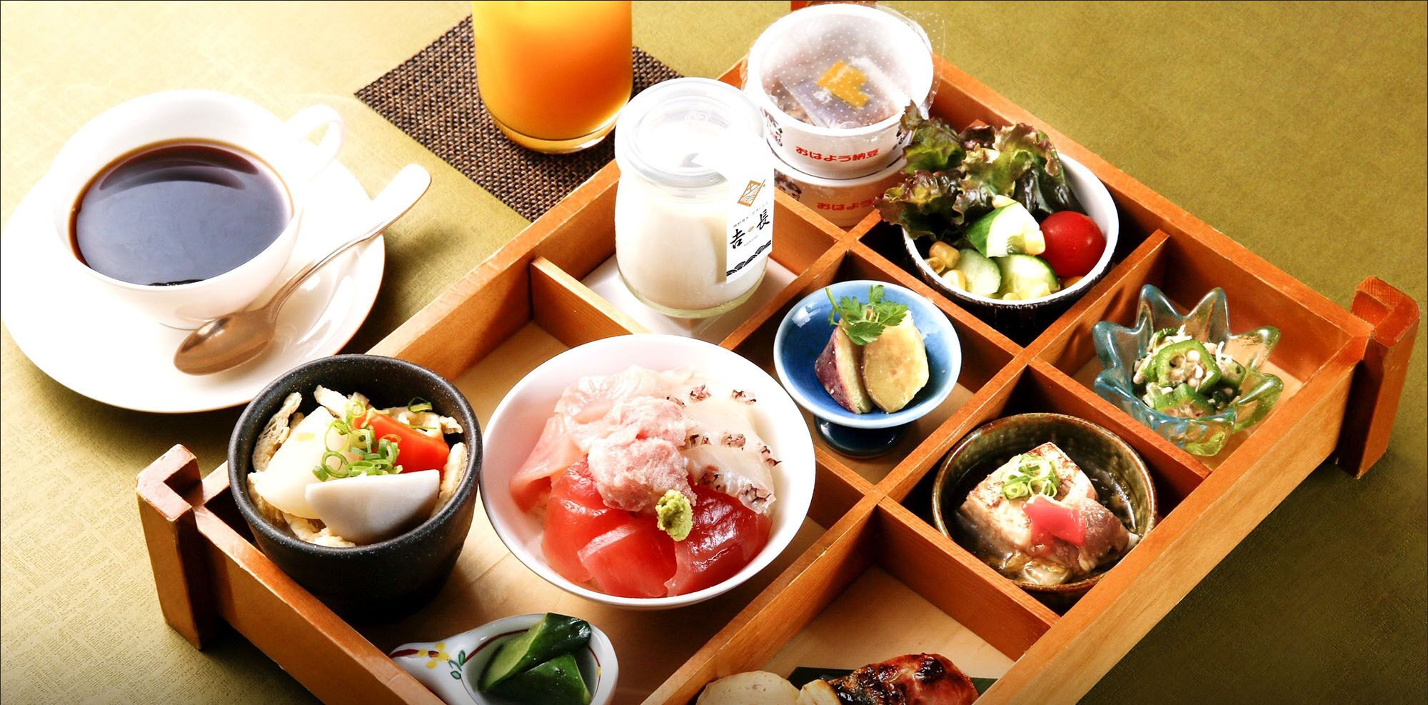 A traditional Japanese meal setup with various dishes and a cup of tea.