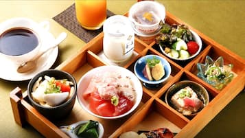 A traditional Japanese meal setup with various dishes and a cup of tea.