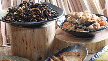 A variety of dishes including a bowl of shredded vegetables, a plate of fried slices, and a bowl of mixed seafood.