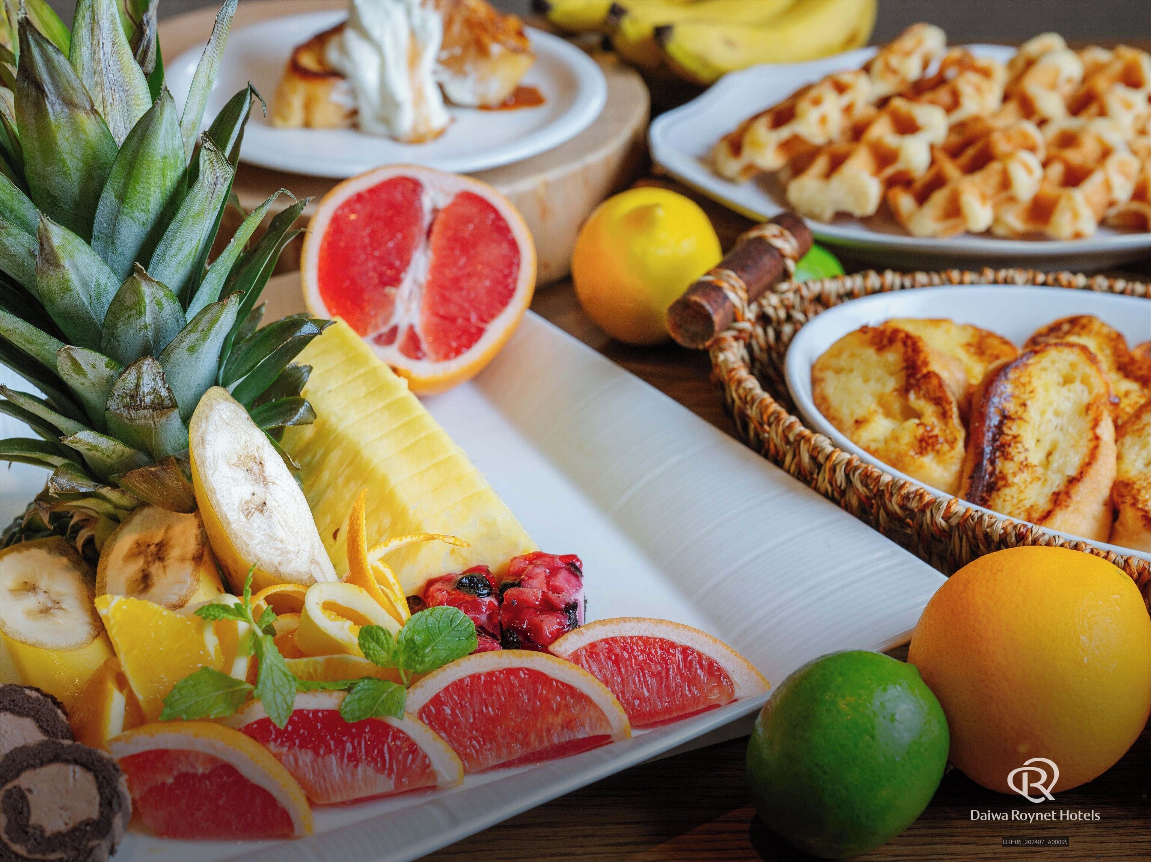 A variety of fruits and pastries on a table.