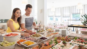 A buffet setup with various food items and a modern interior. - Hotel Cesarskie Ogrody (Swinoujscie)