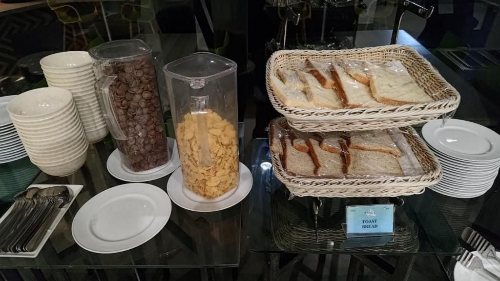 A buffet setup with various food items and serving utensils.