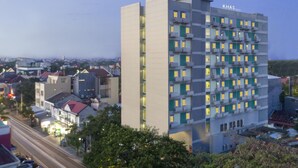 A multi-story hotel with a modern design, featuring balconies and a prominent signage. - Khas Makassar  (Makassar)