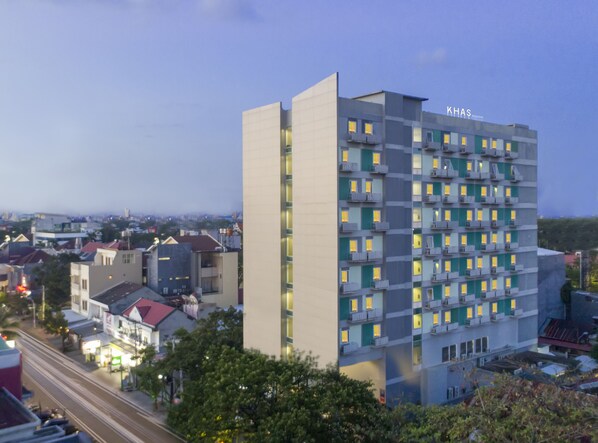 A multi-story hotel with a modern design, featuring balconies and a prominent signage. - Khas Makassar  (Makassar)