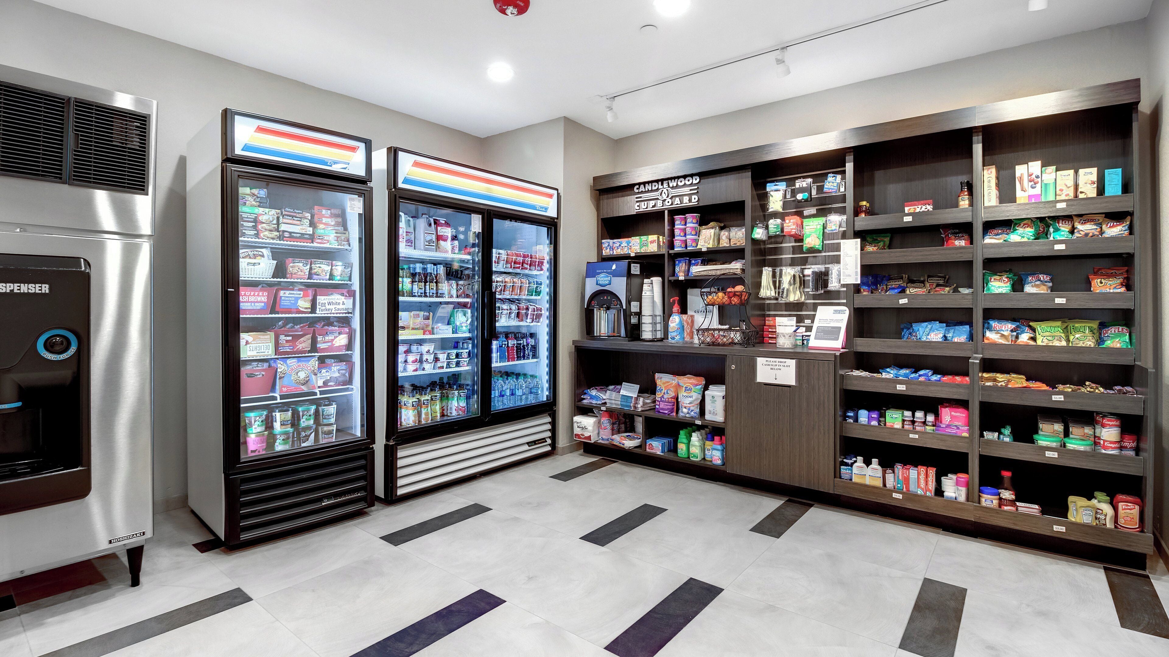 A self-service beverage dispenser, refrigerated display cases, and a variety of packaged goods on shelves.