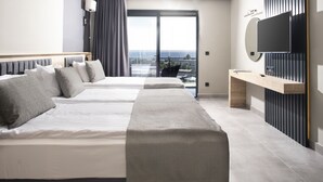 A modern hotel room with two beds, a TV, and a balcony with a city view.