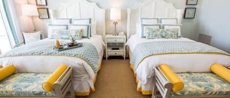 A double room with two beds, each with matching headboards and nightstands.