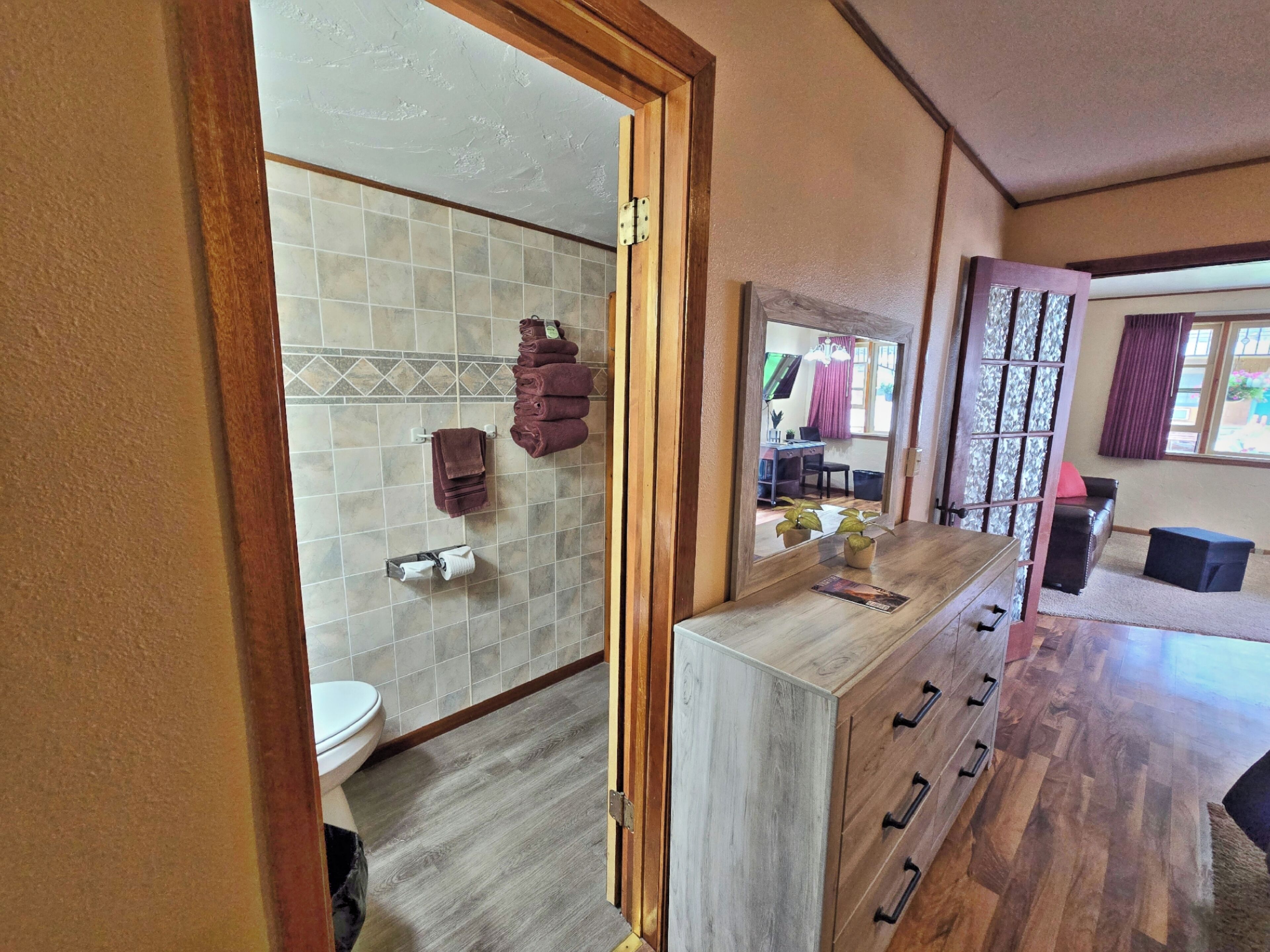A bathroom with a toilet, sink, and towel rack.