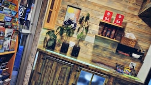 A rustic interior with wooden walls and a counter displaying various items. - Cedar Wood Inn (Deadwood)
