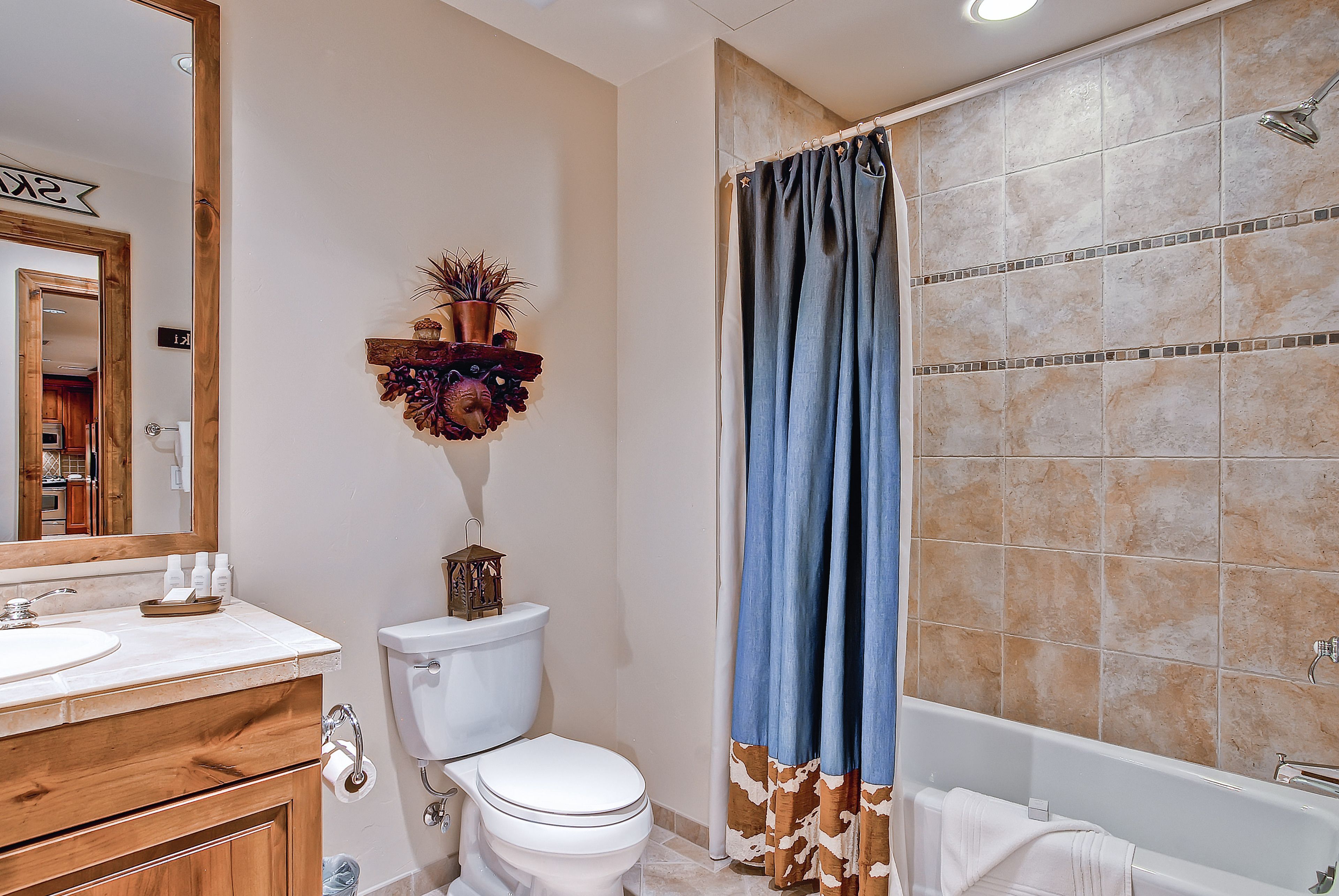 A bathroom with a toilet, sink, and bathtub.