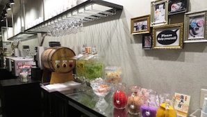 A bar area with a wine cooler, a variety of glasses, and decorative items on the counter. - Design Hotel W Zip Club - Adults Only (Nagoya)