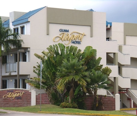 A building with a sign that reads "Guam Airport Hotel".