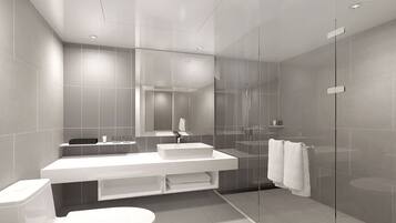 A modern bathroom with a glass-enclosed shower, a white vanity with a sink, and a toilet.