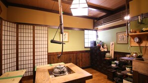 A traditional Japanese room with tatami flooring, a low wooden table, and a shoji screen. - Fukashiso (Matsumoto)