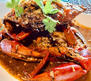 A crab dish with a garnish of cilantro. - Siargao Bleu Resort And Spa (General Luna)