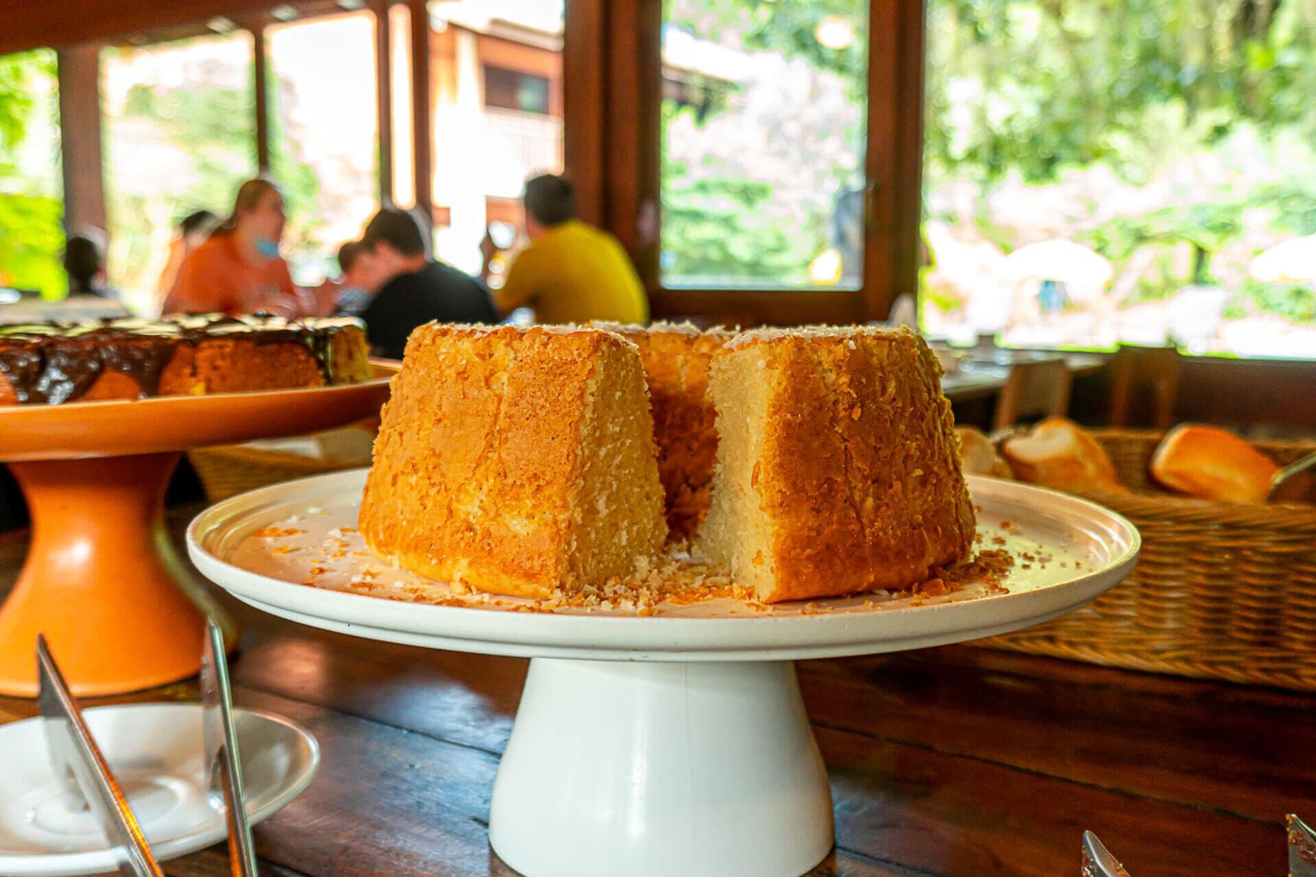 A dessert cake on a white pedestal stand.
