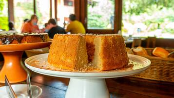 A dessert cake on a white pedestal stand.