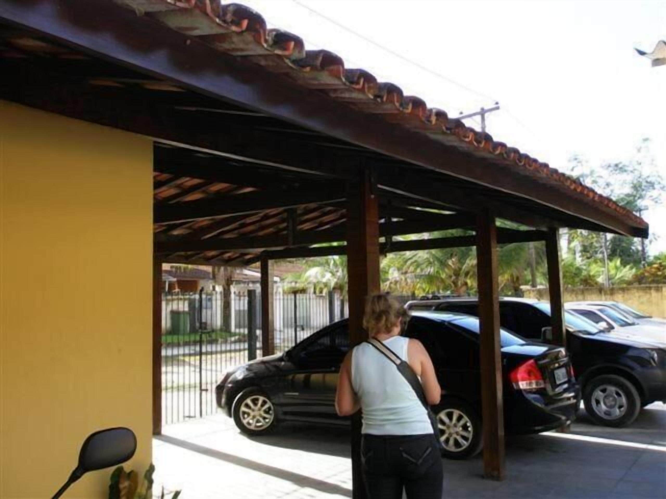 A covered parking area with a car parked under a roof.