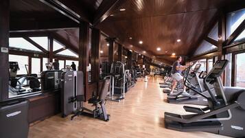 A gym with treadmills, weight machines, and exercise equipment.