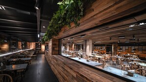 A restaurant with wooden walls, tables, and chairs. - Anyospark Hotel (Anyos)