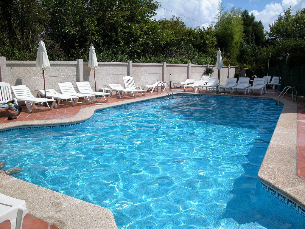 seasonal outdoor pool, pool umbrellas, pool loungers