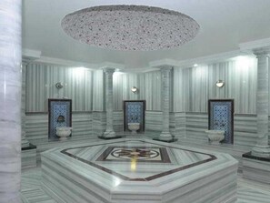 A luxurious lobby with marble flooring, a central circular design, and a large chandelier. - Gypsophila Holiday Village (Alanya)