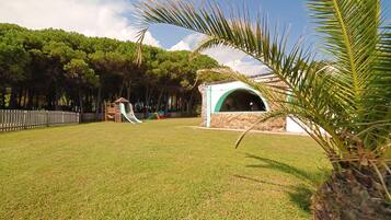 Enjoy an outdoor space with a lawn, play structure, and shaded gazebo.
