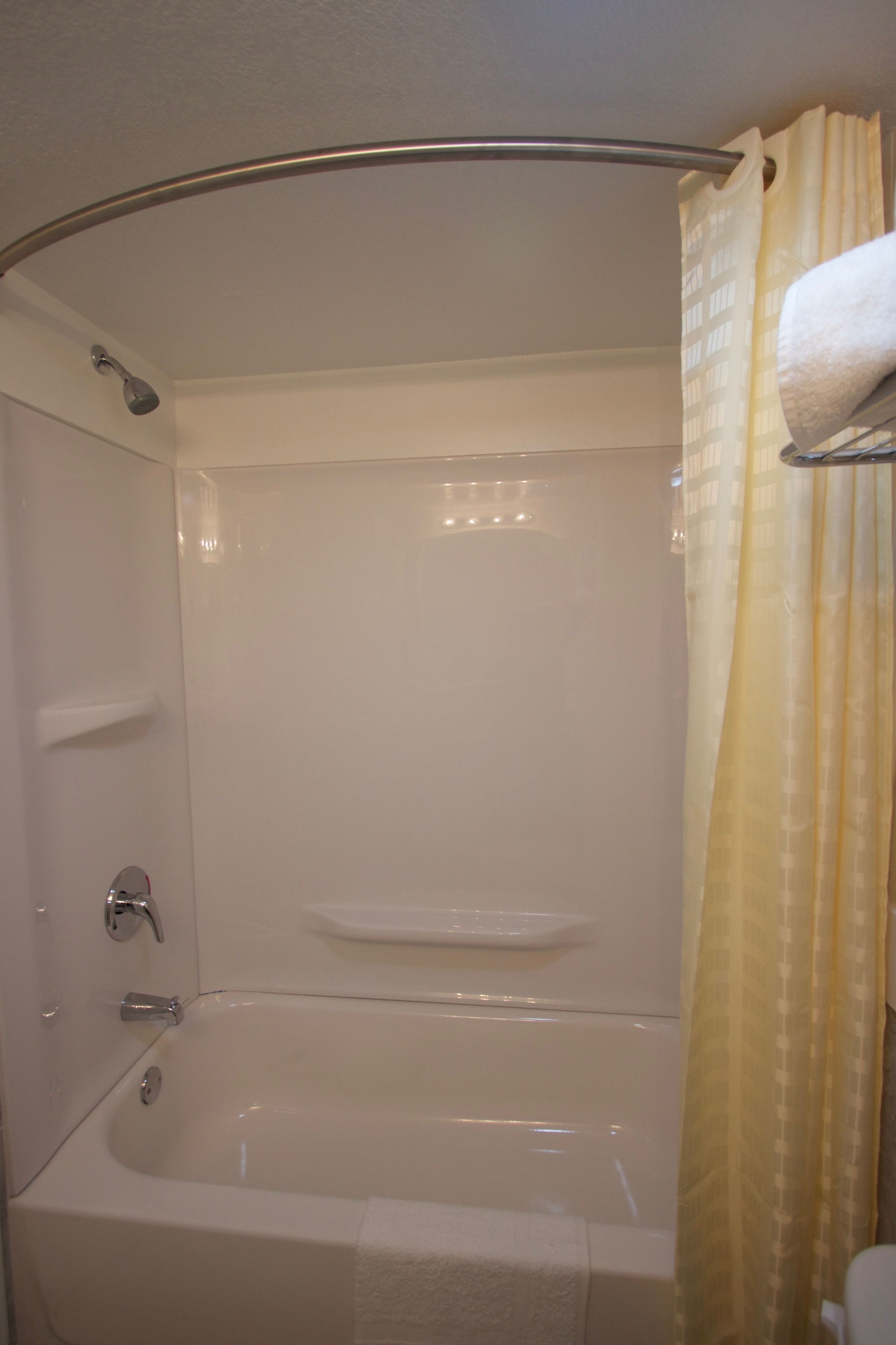 A bathroom with a bathtub, a shower, and a toilet.