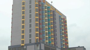 A tall hotel building with colorful vertical stripes on the facade.