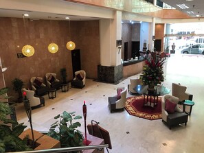 A hotel lobby with seating areas, a reception desk, and a Christmas tree. - Hotel Grand Continental Kuala Terengganu (Kuala Terengganu)