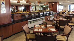 A restaurant with a buffet counter, dining tables, and chairs. - Hotel Grand Continental Kuala Terengganu (Kuala Terengganu)