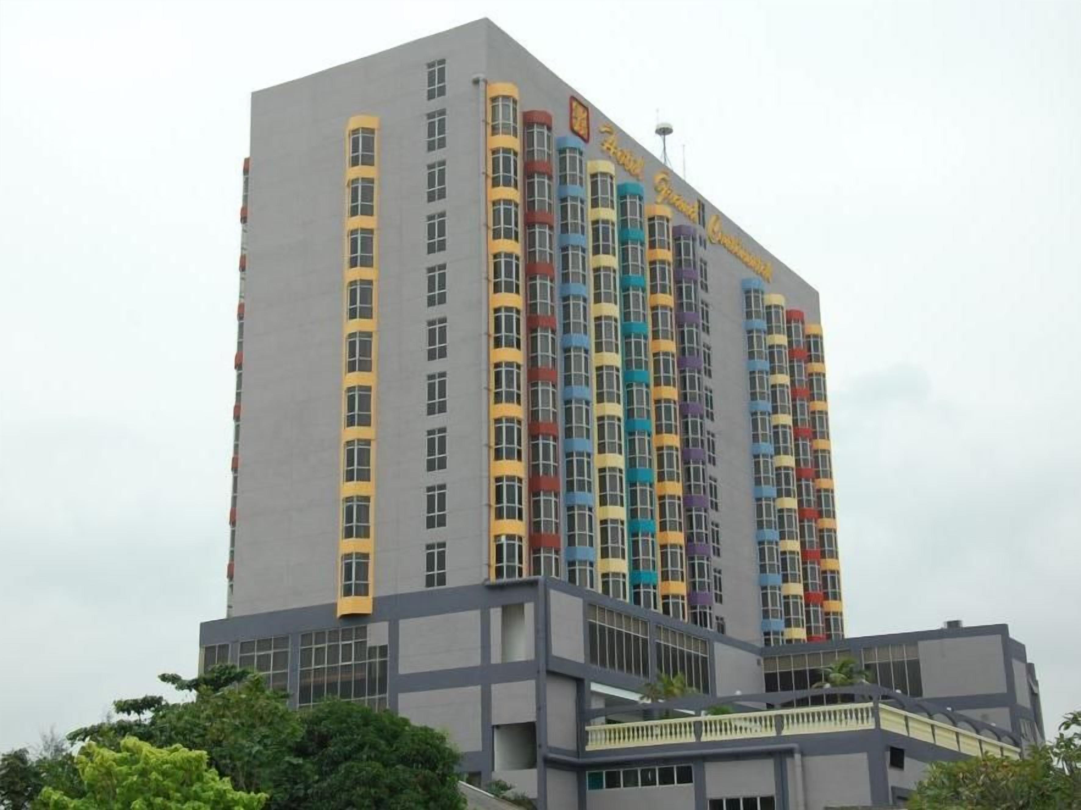 A multi-story hotel with a modern architectural design, featuring a prominent entrance and a series of balconies.
