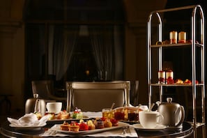A dining table with a tea set, a dessert trolley, and a window with curtains. - Intercontinental Phoenicia Beirut (Beirut)