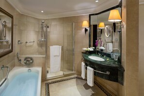 A bathroom with a bathtub, shower, vanity, and large mirror. - Intercontinental Phoenicia Beirut (Beirut)