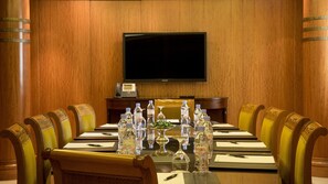 A conference room with a long table, chairs, a flat-screen TV, and a telephone. - Intercontinental Phoenicia Beirut (Beirut)