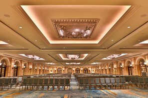 A large conference room with rows of chairs, a grand chandelier, and arched doorways. - Intercontinental Phoenicia Beirut (Beirut)