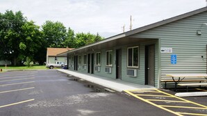 A motel with a row of rooms, a parking lot, and a picnic table. - Eden Valley Motel (Eden Valley)