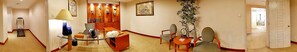 A hotel corridor with a dining area featuring a glass table, chairs, and a lamp. - Suzhou Castle Scholars Hotel (Suzhou)