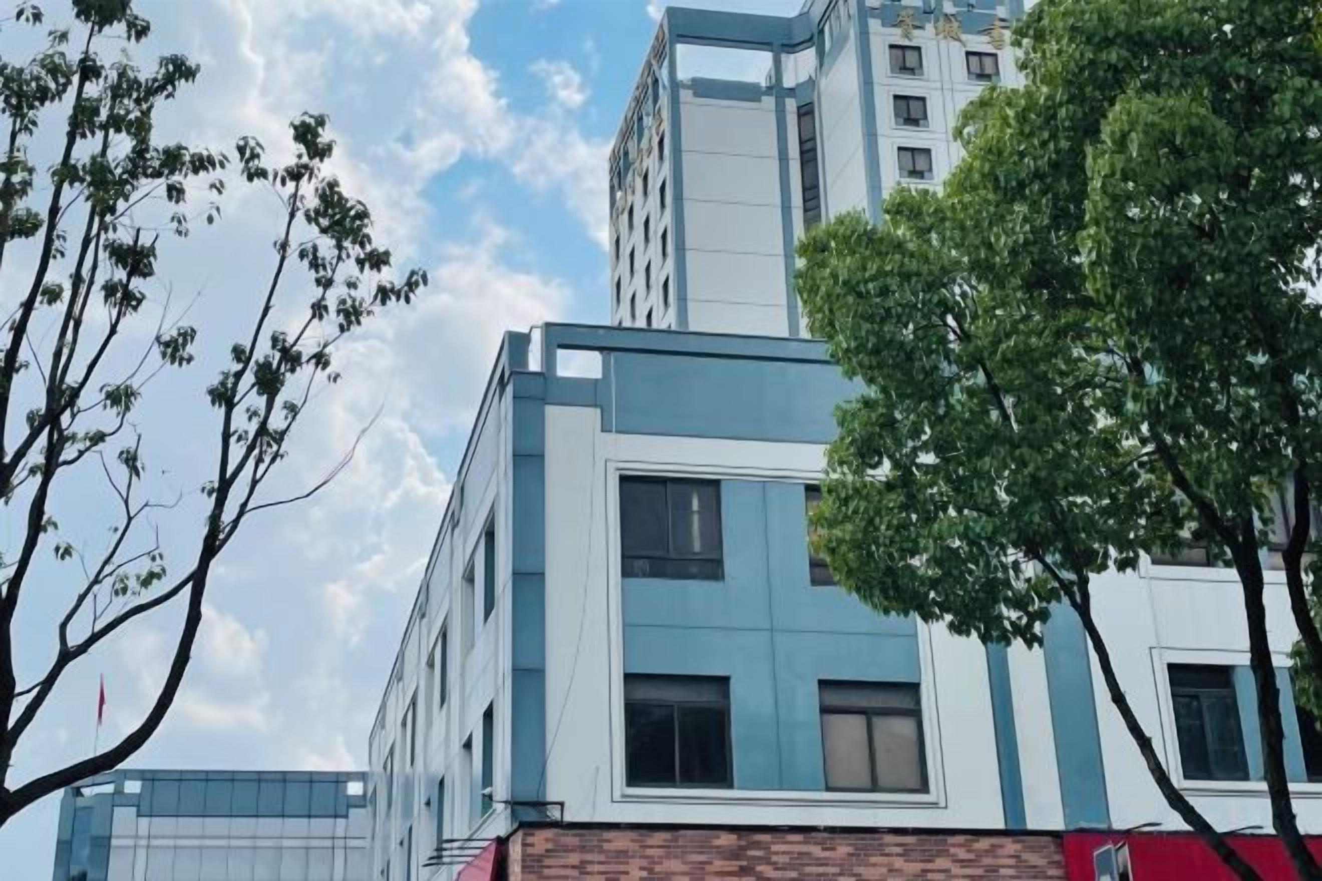 A multi-story building with a modern architectural design, featuring a mix of glass and brick facades.