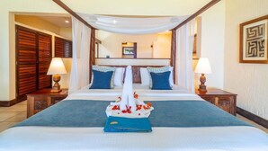 A hotel room with a large bed, two nightstands, a canopy over the bed, and a view of the hallway. - Baobab Beach Resort (Diani Beach)