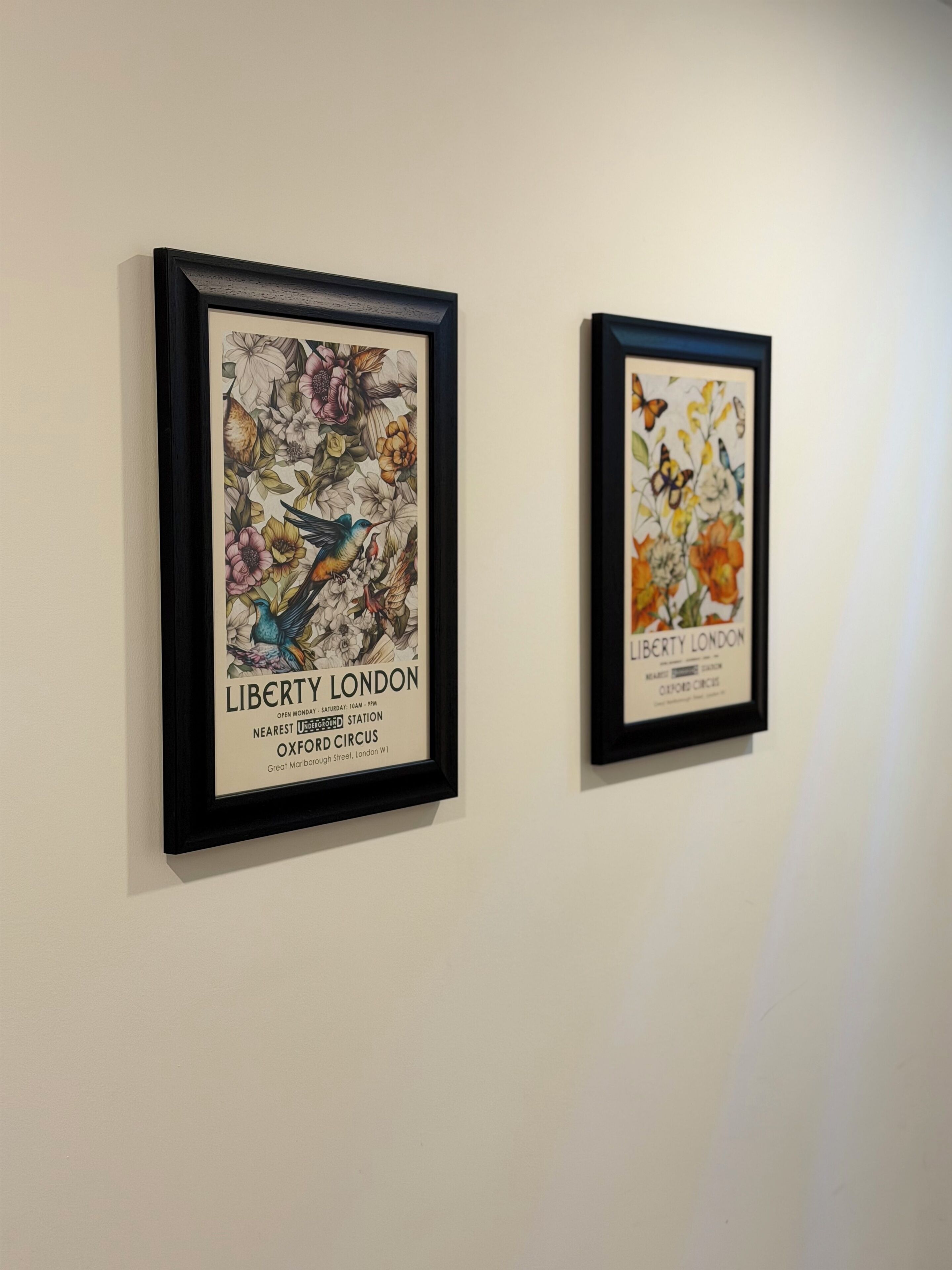 Two framed artworks on a wall.