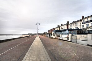A seaside promenade with a walkway, a pier in the background, and buildings including a hotel named "Hatfield Hotel." - Best Western The Hatfield Hotel (Lowestoft)